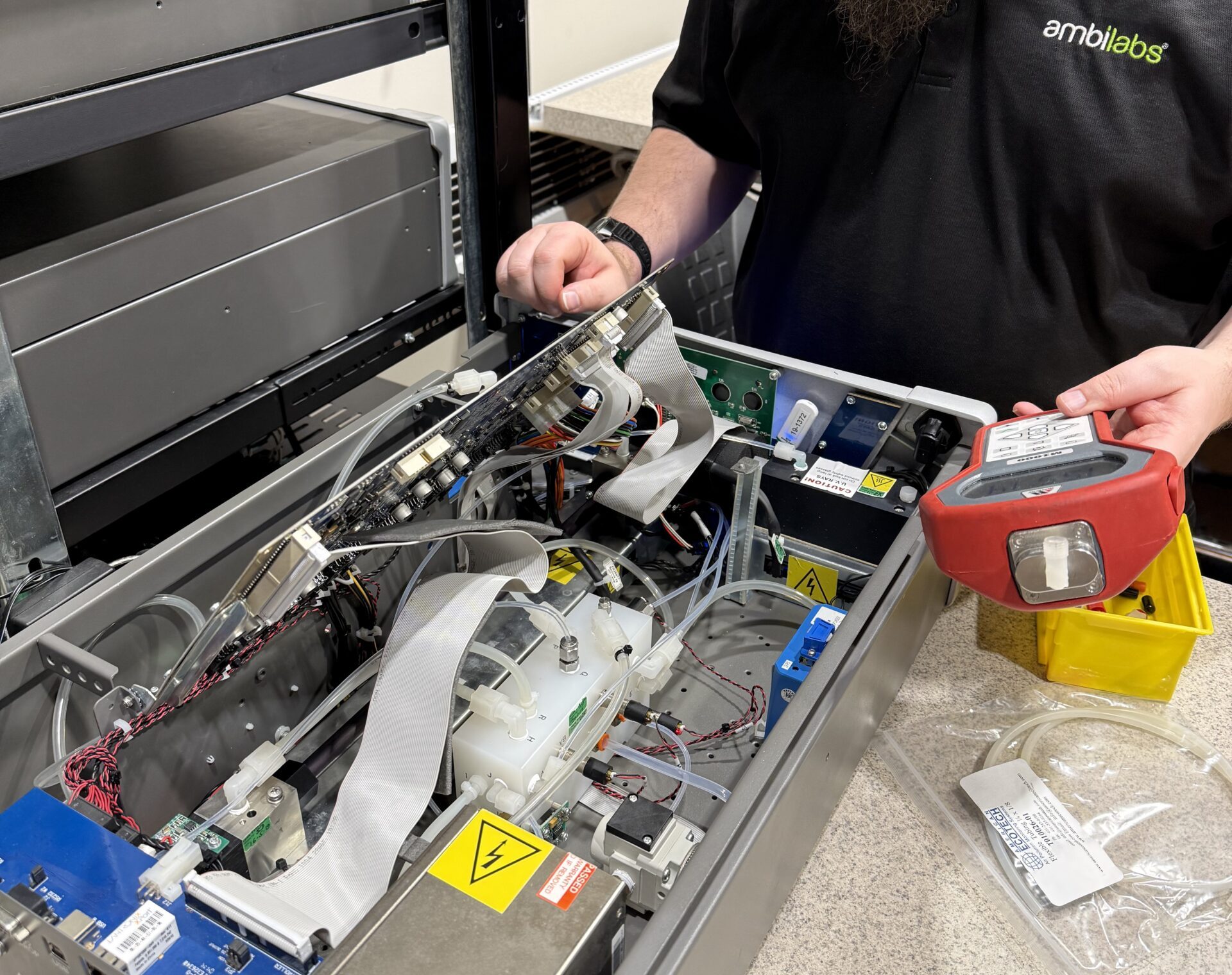 Ambilabs lab service technician working on air monitoring equipment